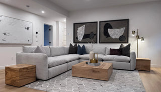 Front view of the Cloud Comfort Sofa styled in a modern living room, showcasing its deep seats, soft cushions, and relaxed silhouette.