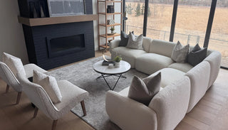 Cream curved “Hug Me” sofa on white background