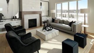 Top view of the Rome Coffee Table in a styled living room, highlighting its smooth surface, rounded shape, and central placement within a cozy seating arrangement.
