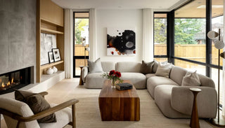 Front view of the Hug Me Sofa in birch pebble color, styled in a cozy living room setting, featuring soft curves, deep seating, and plush upholstery for a relaxed, inviting look.
