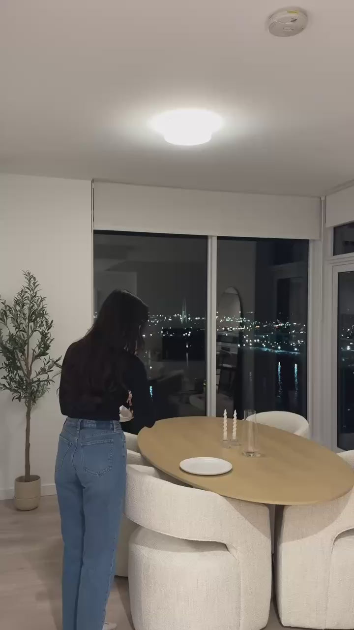 Video of an influencer setting up for dinner with the Porto Dining Table and Birmingham Chairs, styled in a cozy home setting to showcase real-life use and design details.
