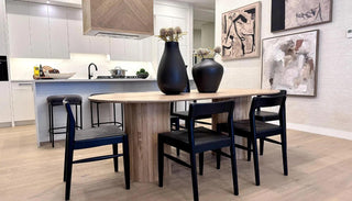 Sicily Dining Table styled in a bright dining area, showcasing its solid wood construction, natural finish, and elegant silhouette perfect for everyday gatherings or special occasions.
